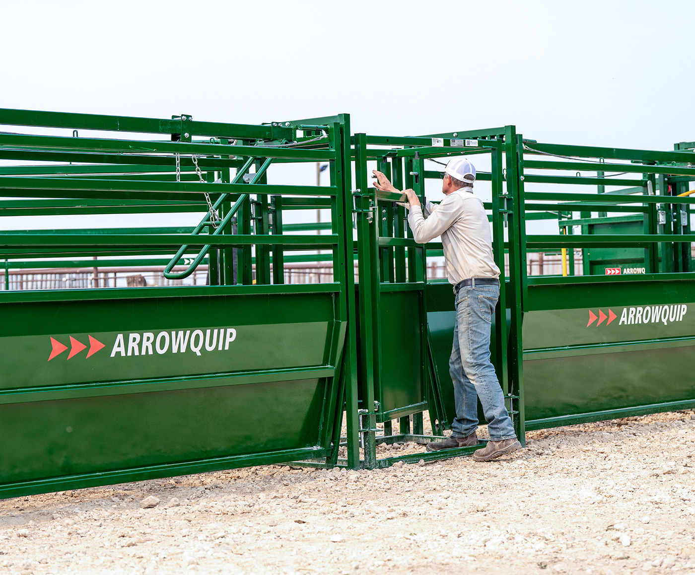 Rancher adjusting one of the sorting gates on the cattle sorting alley in between Easy Flow Adjustable Alleys
