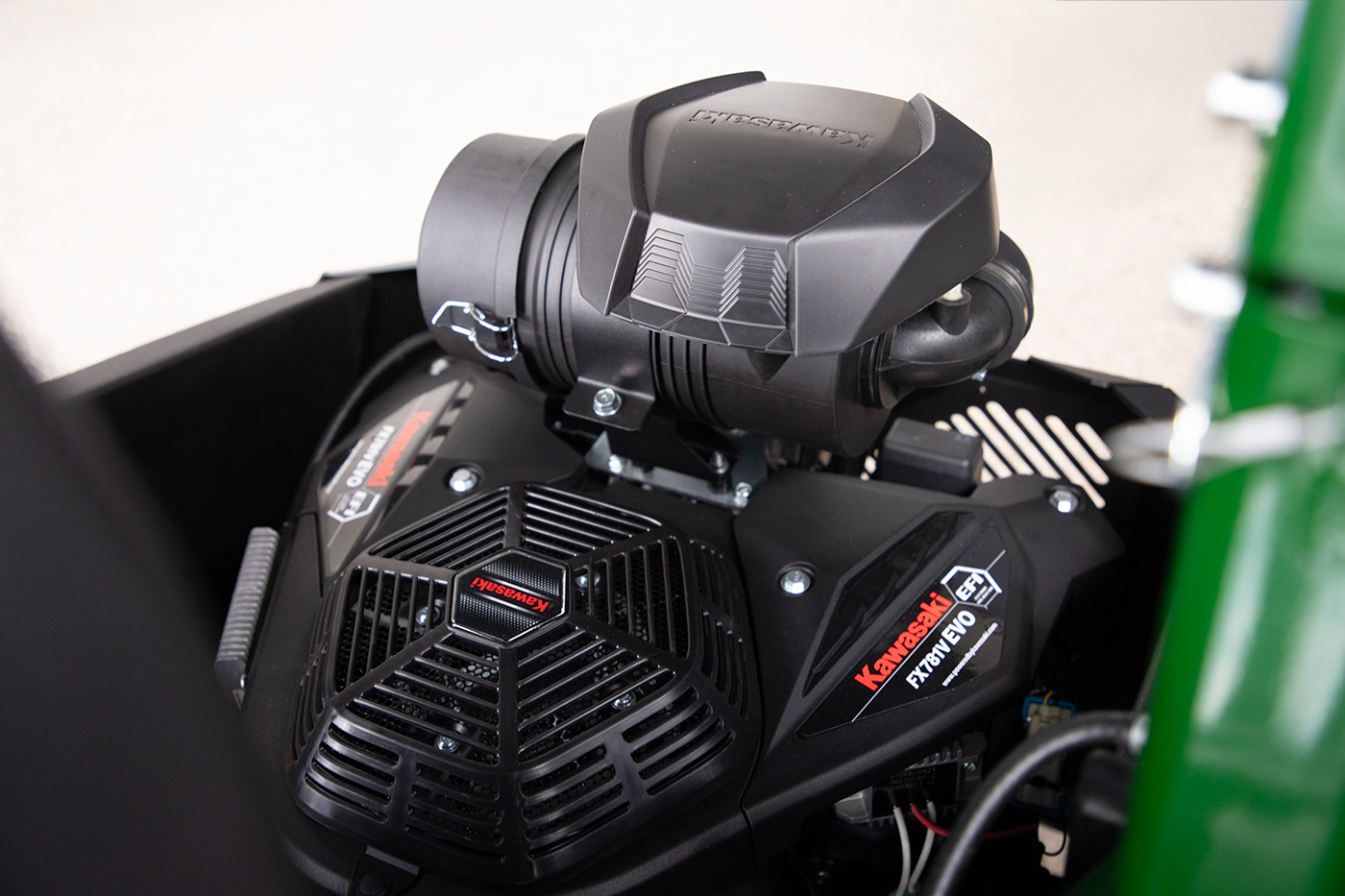 Close-up of Kawasaki engine mounted on Arrowquip 720 zero-turn mower for reliable power