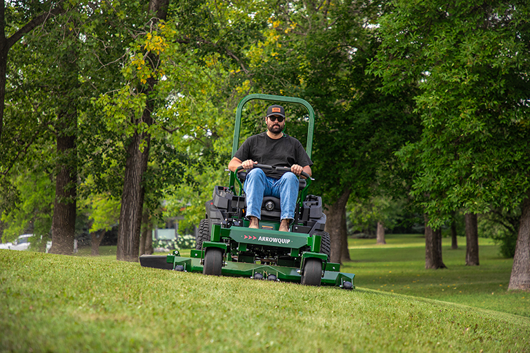 Man on Yakta 320 mower on slight slope on hill