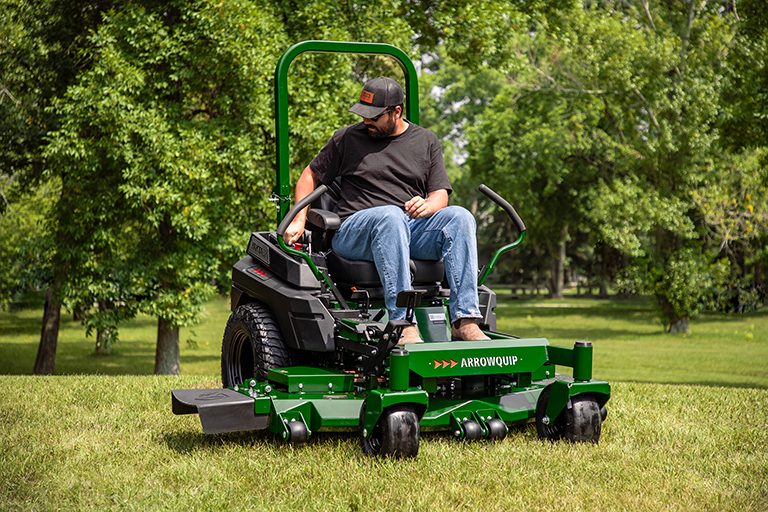 Operator driving Arrowquip Mowers zero-turn mower designed for easy ignition and reliable performance
