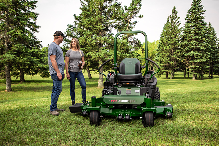 Two people reviewing Arrowquip Mowers zero-turn mower, built for durability and easy maintenance
