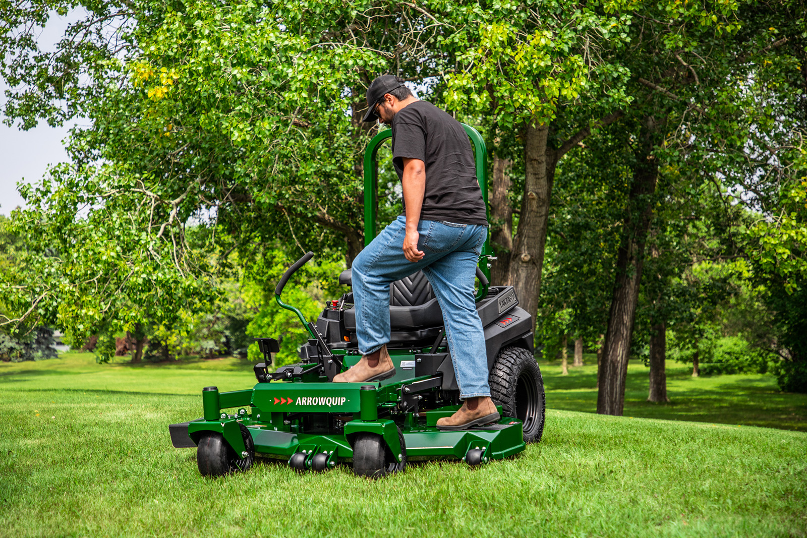 Man stepping on durable Arrowquip mower deck
