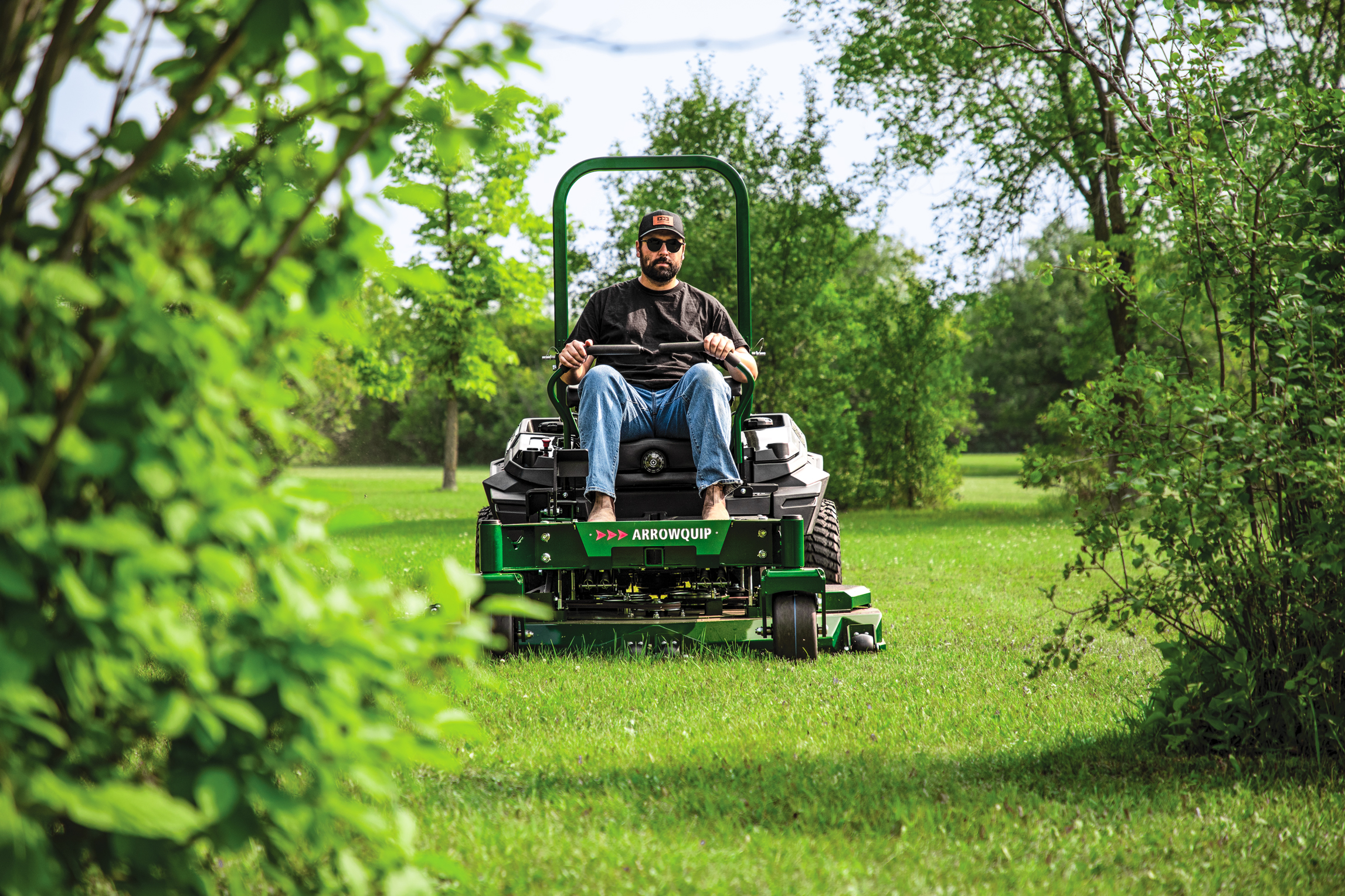 Man approaching trees on Arrowquip mower