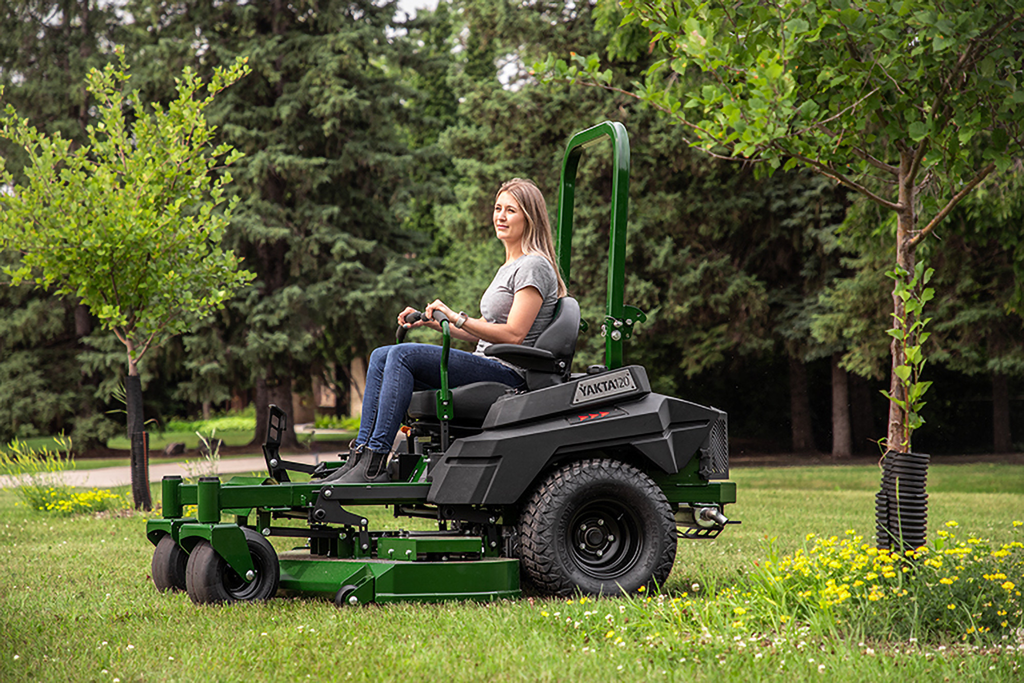 Woman mowing lawn on Arrowquip Mowers zero-turn mower built for comfort, efficiency, and precision