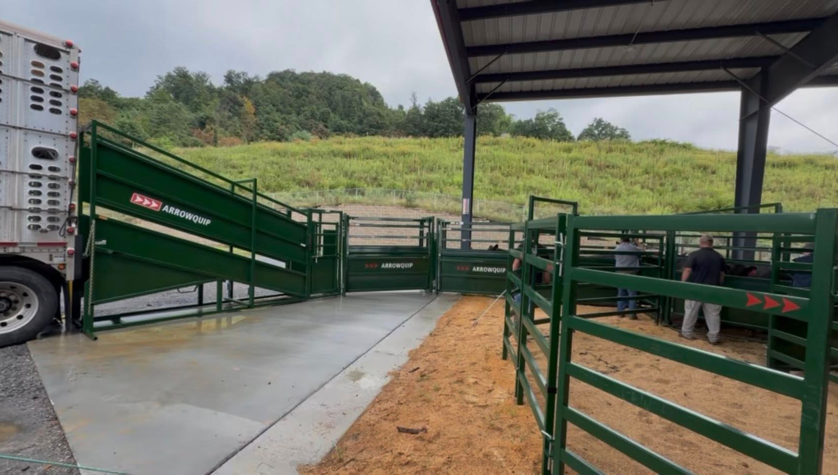 Arrowquip cattle system with ranchers getting ready to load out cattle into a cattle pod with a loading chute