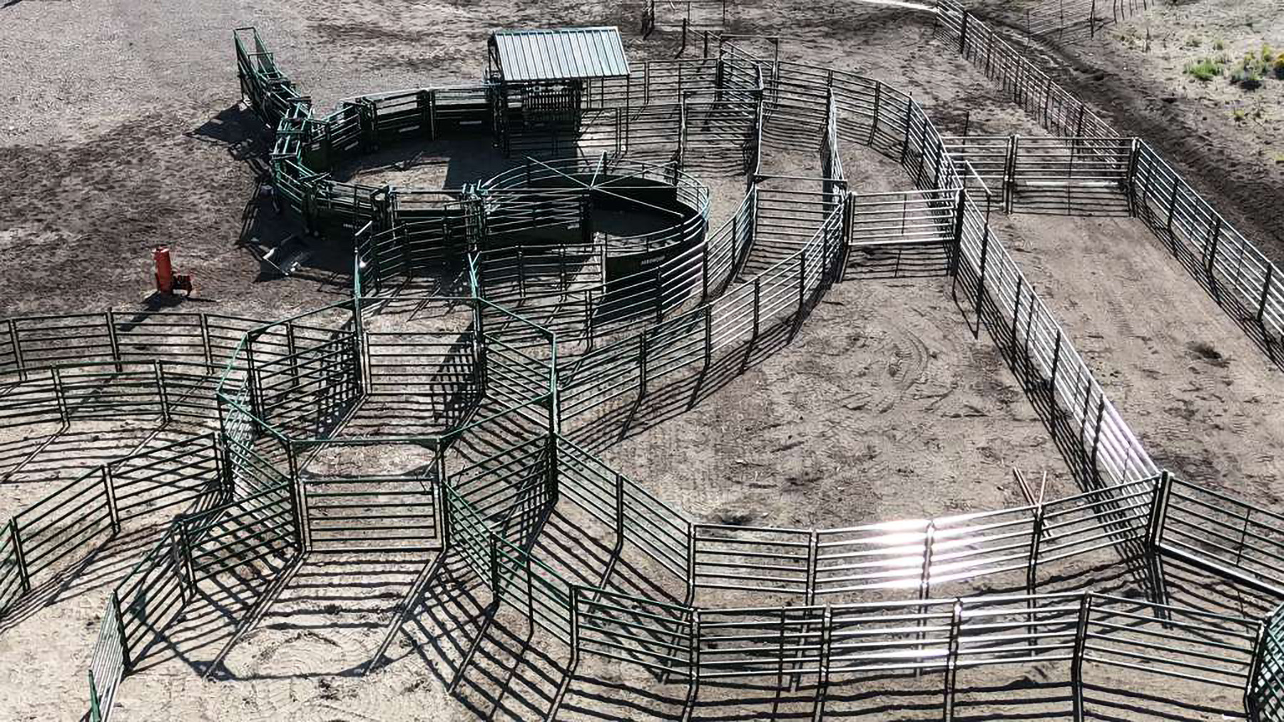 Aerial view of large cattle handling system ready to work cattle complete with draft pound, BudFlow cattle tub and curved alleyway with loading chute and cattle chute