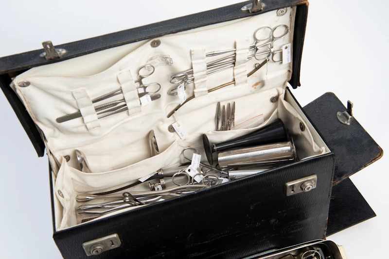 Black rigid bag containing various instruments