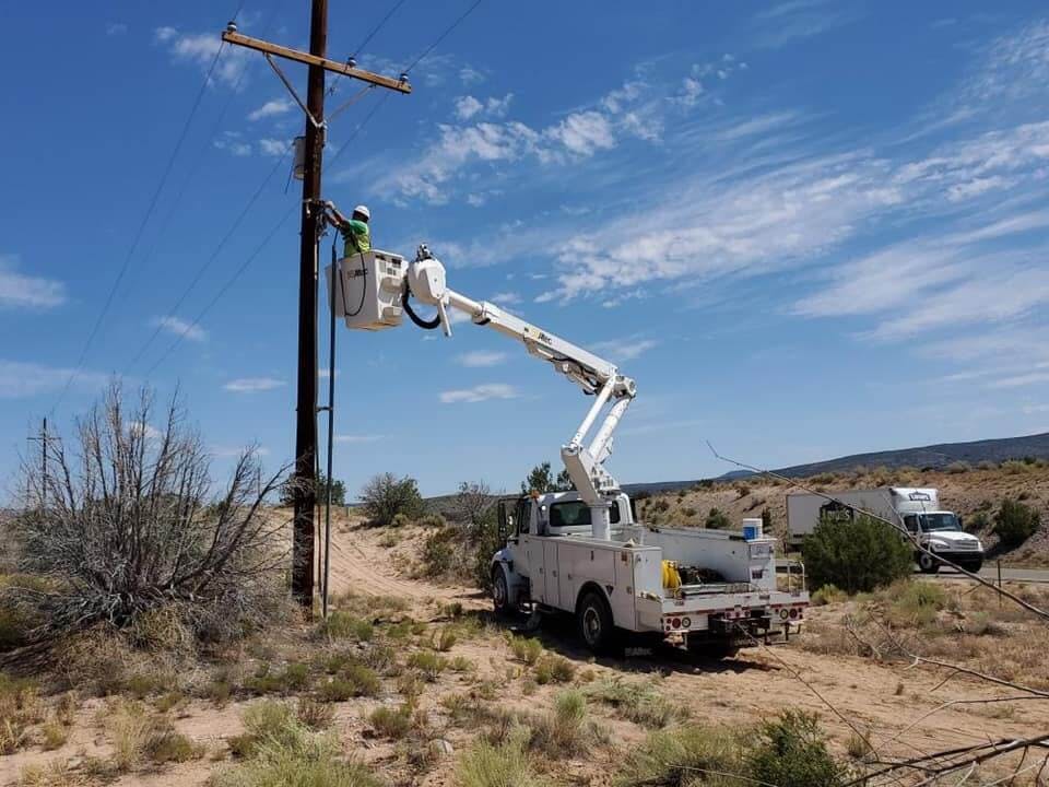 Allied Electric Inc in action Allied Electric Inc working on Powerlines with bright blue sky