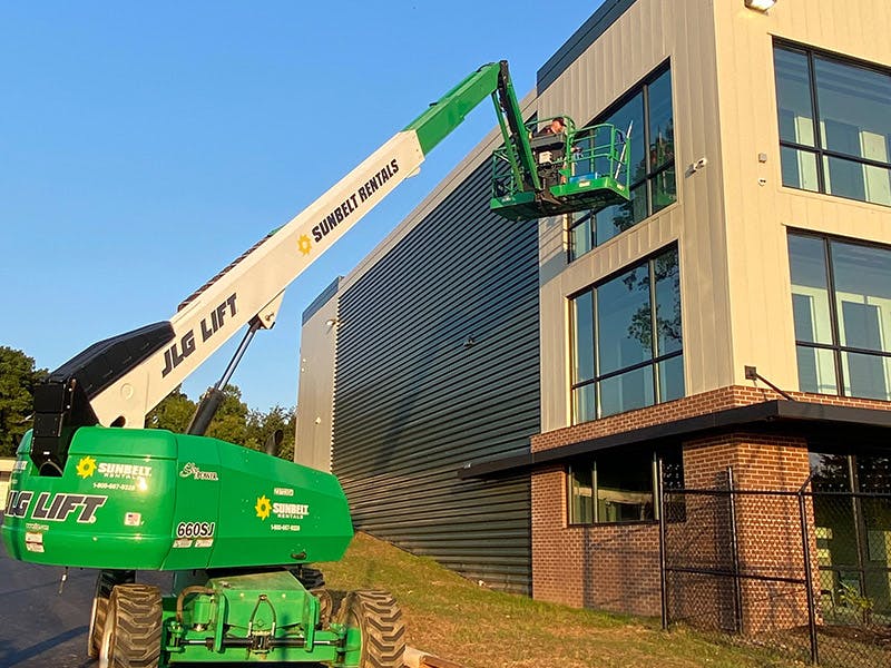 Clean Right Solutions LLC uses equipment to clean high rise building windows