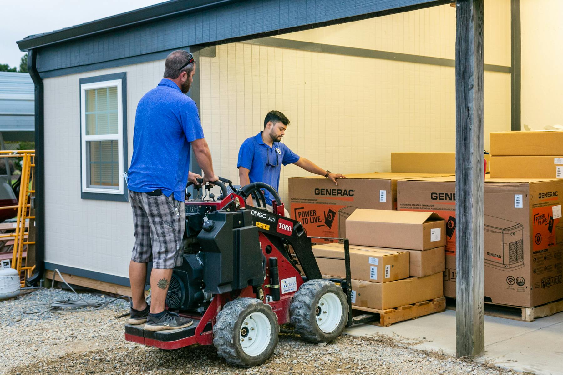 Mabry'c Electrical Inc employees moving boxes with small forklift