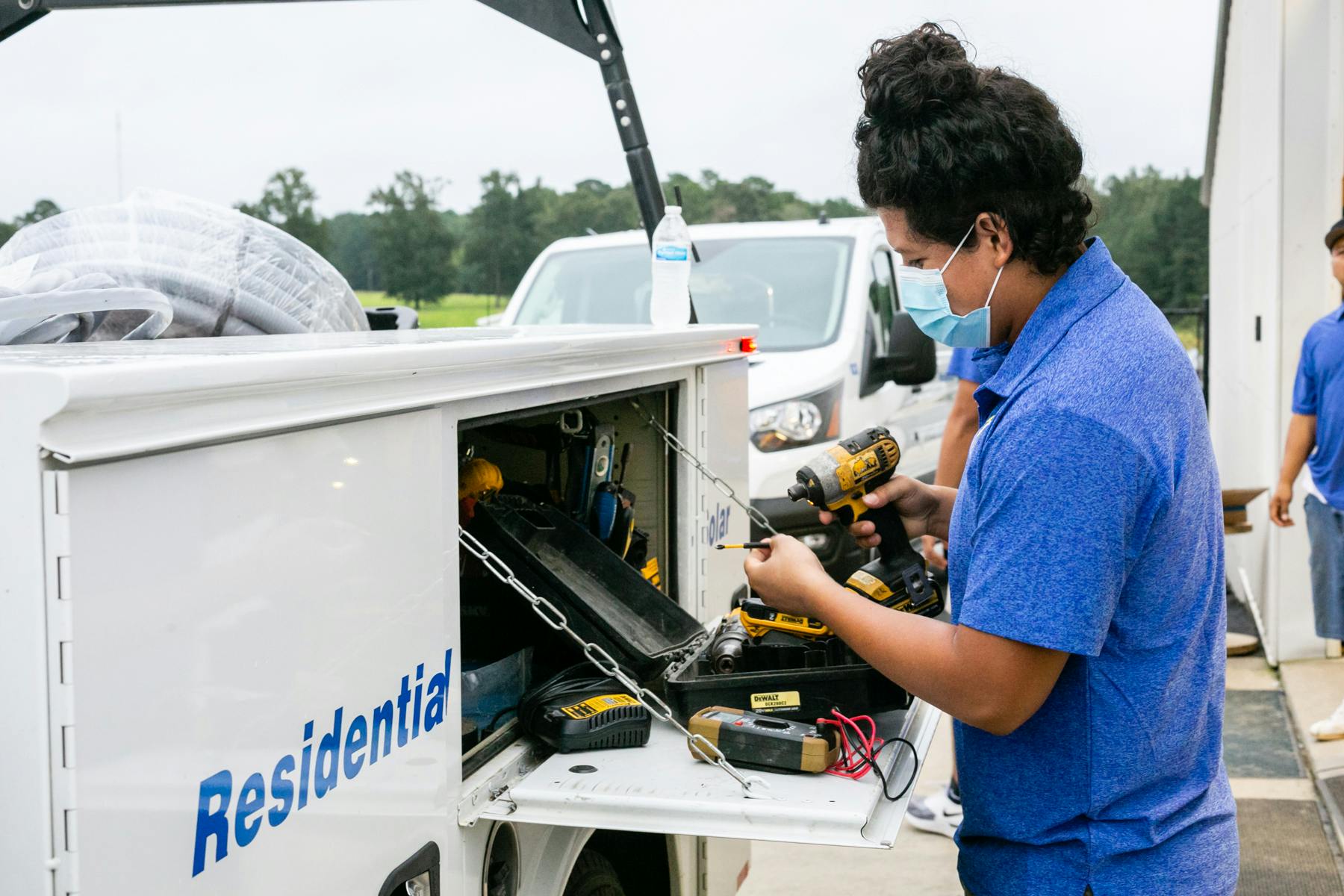 Mabry'c Electrical Inc Employee using toolset in van