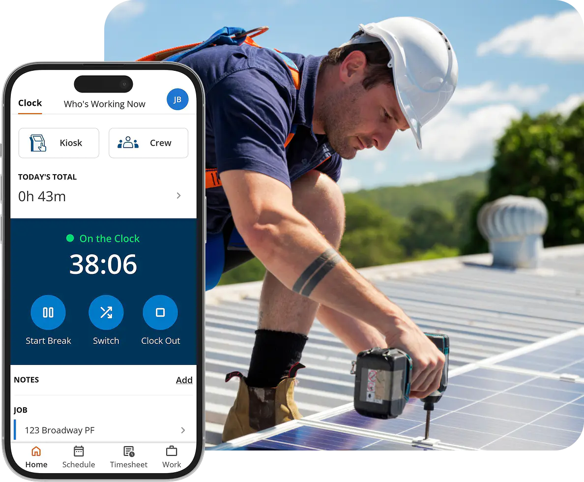 Solar installer uses ClockShark app while securing panel on roof.
