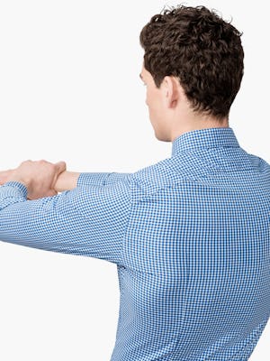 Men's Blue Gingham Aero Dress Shirt on Model Stretching Backward to Show Back Yoke Stretch