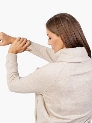 Women's Oatmeal Hybrid Fleece Funnel Neck on Model Stretching Her Arm