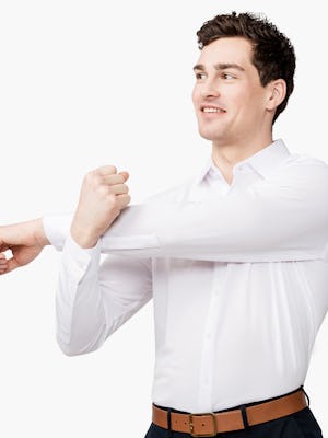 Men's White Brushed Apollo dress shirt model facing forward with left arm stretched across body