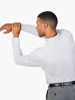 Men’s Grey Stripe Gemini Knit shirt model facing backward with left hand grabbing extended right arm