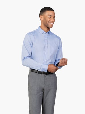 Men’s Blue Gemini Woven shirt model facing forward and adjusting left cuff