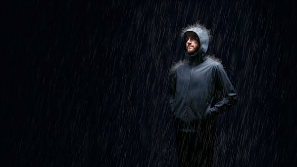 Man standing in rain wearing Doppler Jacket