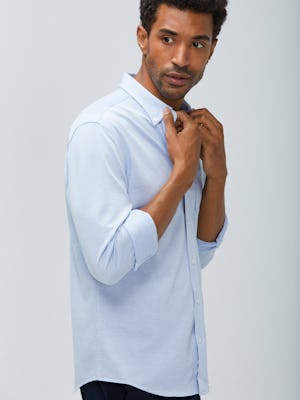 men's blue heather stripe hybrid button down zoomed shot of model facing right with sleeves cuffed