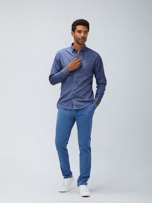 Men's indigo heather gingham aero button down and storm blue momentum chino model facing forward with hand in pocket