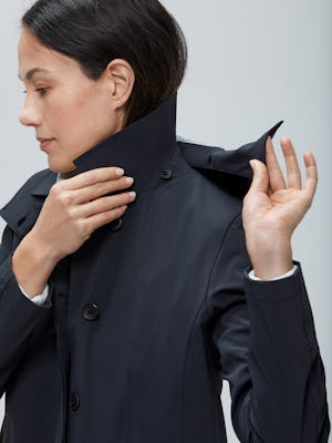 Close up of Women's Black Doppler Mac on model removing hood