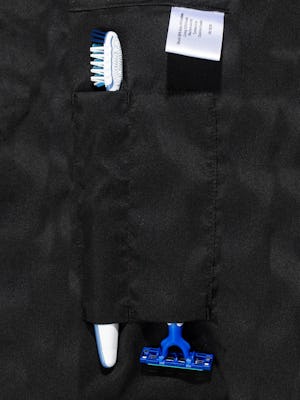 doppler essentials kit zoomed shot of organizational slots holding toothbrush and razor