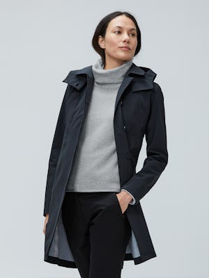 model wearing women's black doppler mac raincoat and women's marble hybrid fleece funnel neck