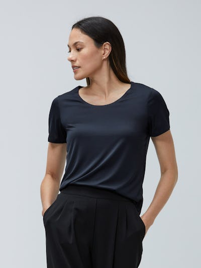 Women's Black Luxe Touch Tee and Women's Black Swift Drape Pant on model facing forward with legs crossed