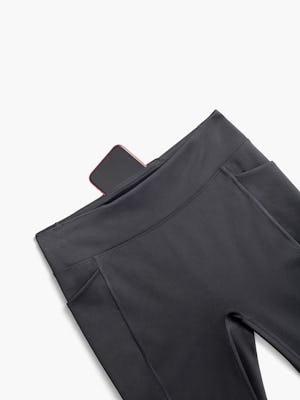 women's black joule active legging zoomed shot of flat with smartphone sticking out of the hidden back pocket