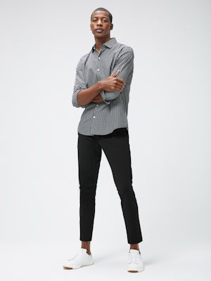 Men's Black Grid Aero Zero Carbon Neutral Shirt and Men's Black Kinetic Tapered Pant on Model with arms crossed