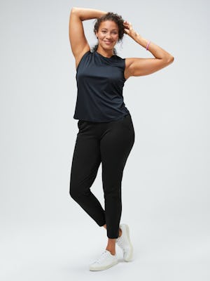 women's navy luxe touch tank and black kinetic pull on pant model facing forward with hands on head