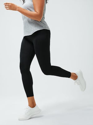 women's black joule legging zoomed shot of model running