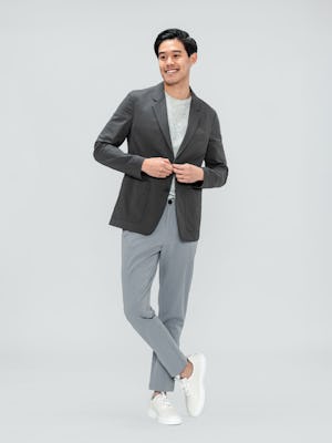 Men's Charcoal Kinetic Blazer over Men's Pale Grey Heather Composite Merino Tee with Men's Light Grey Momentum Chino on model adjusting button
