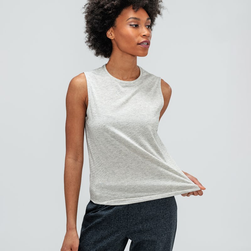 Women's Grey Heather Composite Merino Tank and Women's Grey Glen Plaid Fusion Ankle Pull-On Pant on model stretching shirt