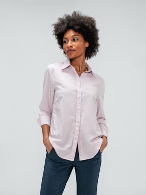 Women's Azurite Heather Velocity Pant and Rose Quartz Juno Blouse on model with hand in pant pocket