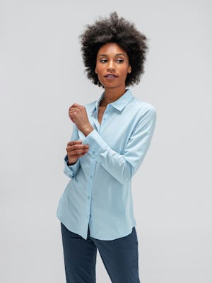 Women's Light Blue Juno Recycled Tailored Shirt on model adjusting sleeve