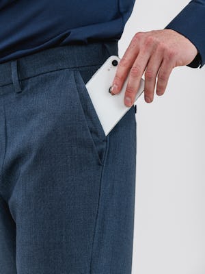 model inserting iphone into stacked side pocket of men's azurite heather velocity pants