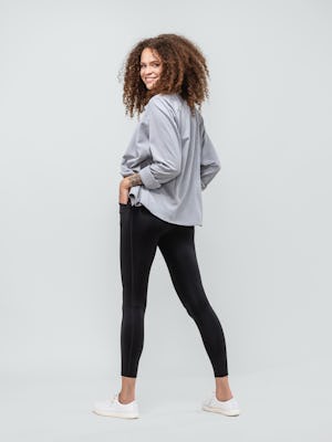 model wearing joule active legging black and womens apollo shirt grey white heather looking backwards full body
