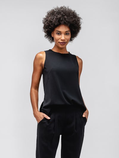 Black Swift Sheath Tank on model standing forward with hands in pockets