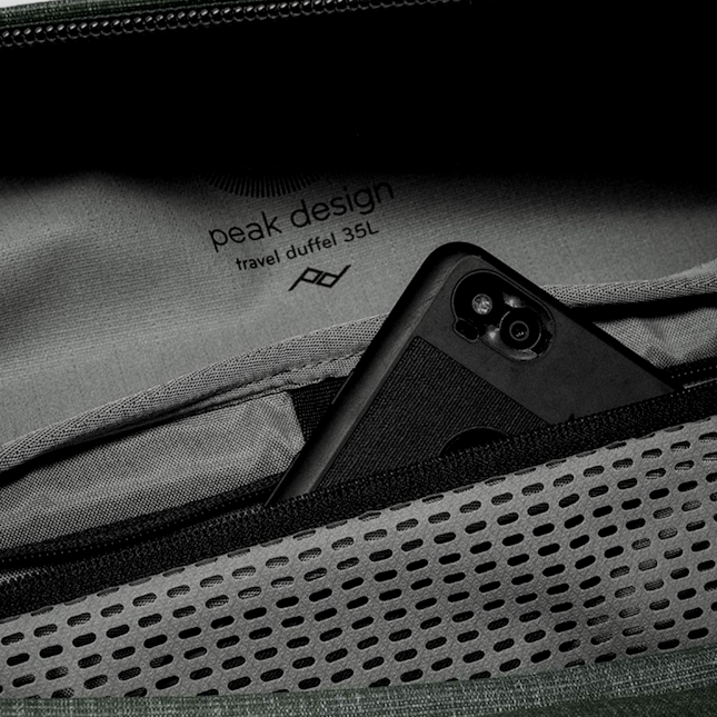 Close up of green duffel bag zipper features