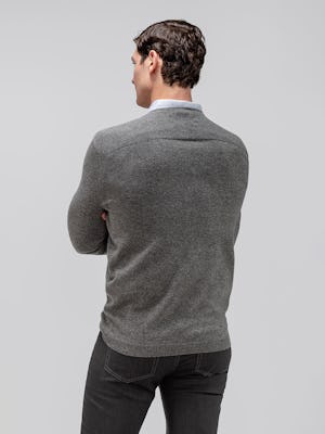 model wearing men's dark grey chroma denim and grey heather stripe hybrid button-down and medium grey atlas merino crew neck sweater facing away from camera
