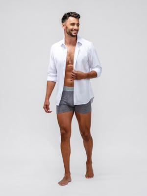 model wearing men's medium grey heather composite merino boxer brief and white aero zero dress shirt facing forward with shirt unbuttoned