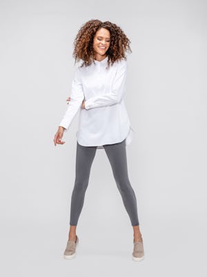 model wearing women's white aero zero tunic and charcoal heather joule active legging facing forward