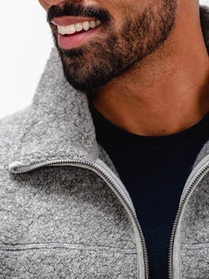 model wearing grey heather composite merino ecofleece and navy composite merino long sleeve tee close up of unzipped collar and neckline