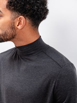 model wearing men's dark charcoal heather composite merino mock neck close up of shoulder and neckline