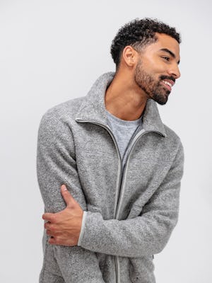 model wearing grey heather composite merino ecofleece and charcoal grey heather composite merino long sleeve tee facing off center with arm across chest