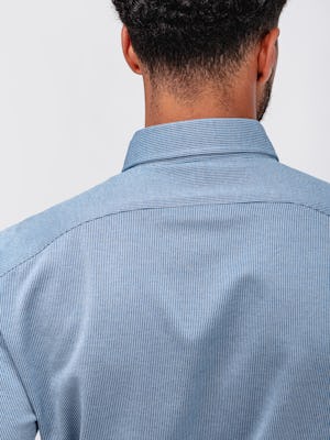 close up of model wearing chambray stripe hybrid button down facing away