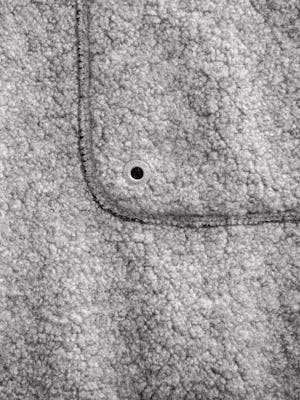 men's grey heather composite merino ecofleece close up of pocket stitching and degree symbol
