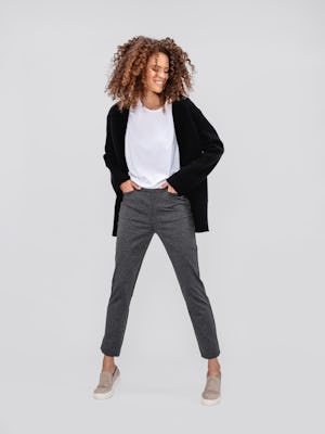 model wearing women's charcoal heather fusion straight leg pant and white luxe touch tee and black composite merino cardigan facing forward with hands in pants pockets