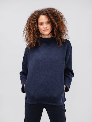 model women's indigo heather hybrid mock neck sweater and navy herringbone fusion straight leg pant facing forward with hands in pockets
